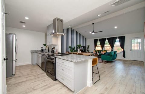 This spacious kitchen is fully equipped for all your cooking needs, and also offers plenty of high-top bar seating for those looking to grab a quick bite.