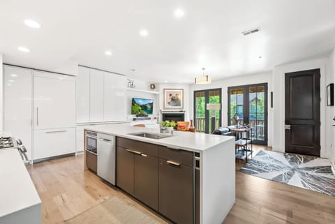 - Cook with ease in a modern kitchen with sleek design  
- Large island with built in sink for meal prep and serving  
- Open floor plan connects directly to the cozy living area