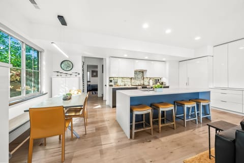 - Dine together at the modern family style table  
- Spacious open layout connects kitchen and dining  
- Large island with bar seating is perfect for gathering