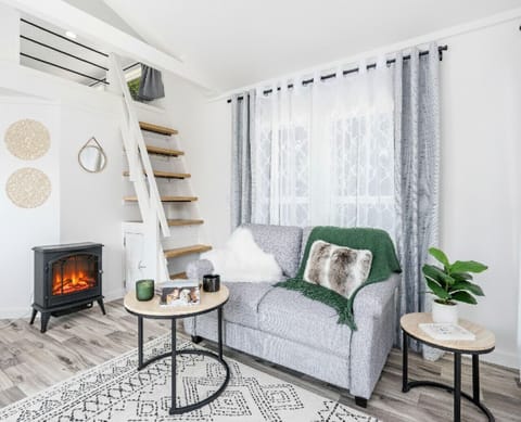 Living Room: Relax and unwind with stunning natural light and a charming electric fireplace!