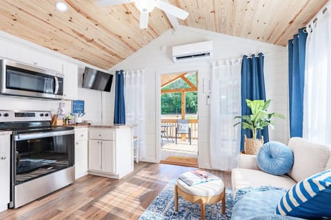 Heron Haus is a romantic tiny house cabin with comfortable interiors and fun exteriors! Step out on the spacious deck with your favorite beverage, hang out by the firepit or play a game in the outdoor game area. This is a fun lovers escape from the ordina
