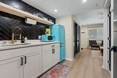 Kitchen with full size fridge, microwave, portable cooking top