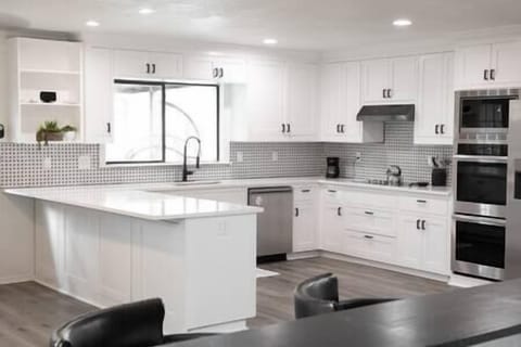 Pristine kitchen with plenty of built-in cabinets and quartz countertops