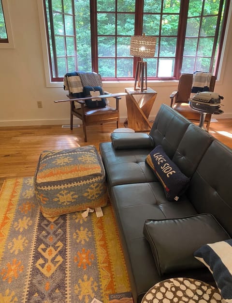 Forest view on the side. Cozy couch.