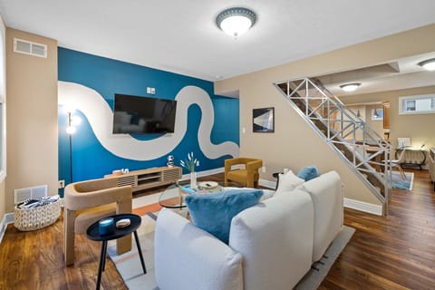 Living room with mounted tv rack and white plushy couch