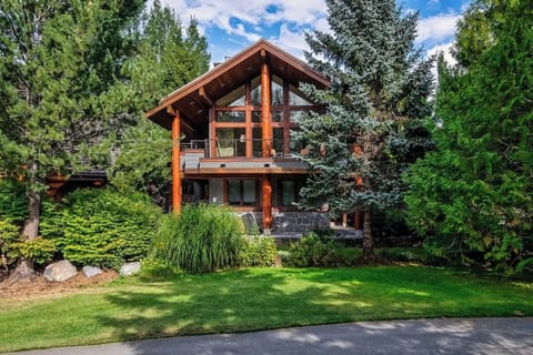 - Stunning cabin exterior framed by trees and natural greenery  
- Floor-to-ceiling windows bring nature into every corner  
- Ideal mountain escape blending rustic charm and modern comfort  
