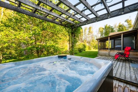 Soak in the outdoor hot tub under the stars—pure relaxation during your cottage vacation retreat.