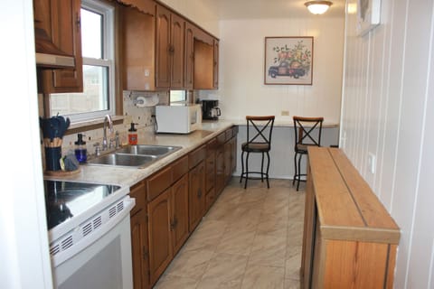 A fully stocked kitchen with plenty of counter space — perfect for easy meals, morning coffee, and gathering while you cook.