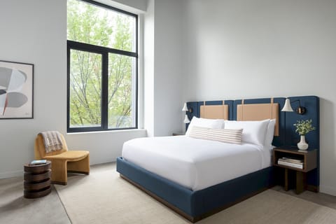 King Sized Bed, Premium linens, noise cancelling machine, armchair/footstool, bedside lamps, blackout shades. 