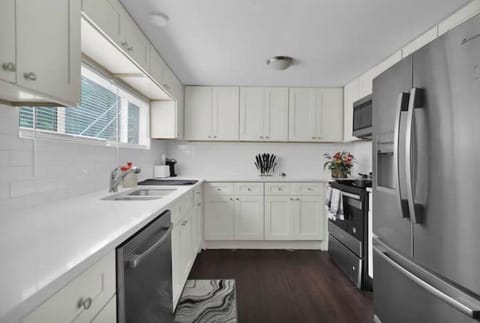 Furnished Kitchen with Full fridge, stove, microwave, silverware, plates & pots.