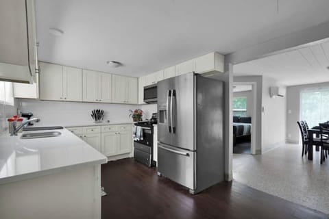 Furnished Kitchen with Full fridge, stove, microwave, silverware, plates & pots.