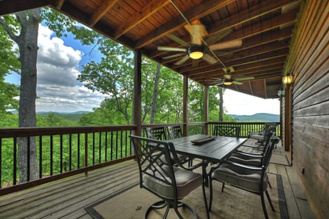 Dining Al Fresco on the spacious covered deck with beautiful mountain views at this Blue Ridge cabin rental