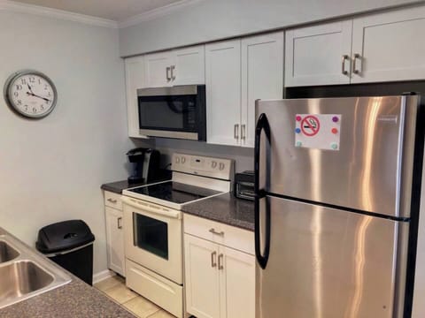 Where Culinary Wonders Unfold: A Sleek and Well-Equipped Kitchen
