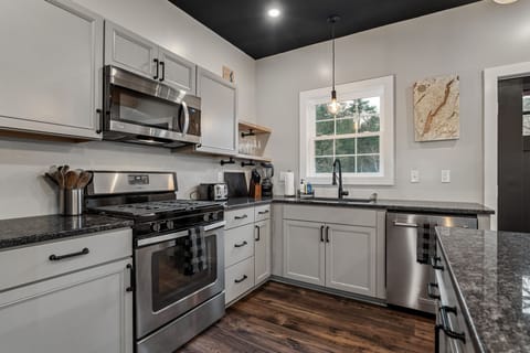 Kitchen outfitted with new appliances, dishes, silverware, bakeware, cookware.