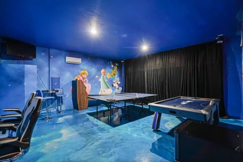 Experience endless fun in this lively game room with ping pong and air hockey tables, perfect for family entertainment.