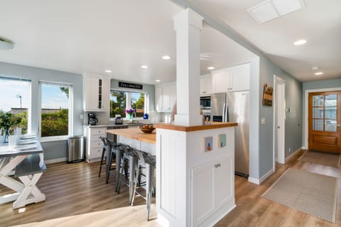 Living room with Wood stove, updated couches and open to dining and kitchen. Smart TV