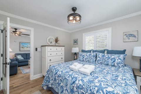 Master with king bed, dresser, closet, and ensuite bathroom with walk-in shower
