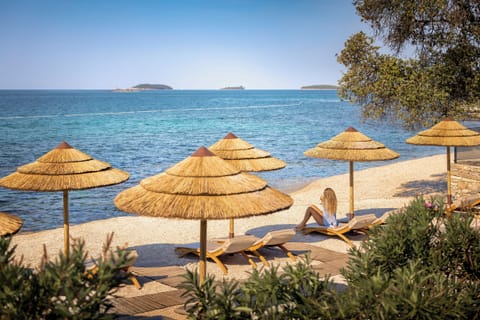 On the beach, sun loungers, beach umbrellas, surfing