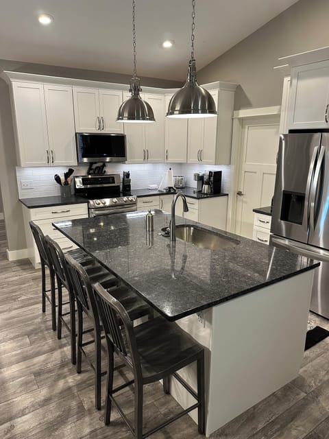 Kitchen with granite countertops, plenty of room for cooking and bar seating