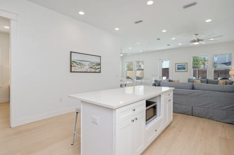 Large kitchen island with 4 bar stools and microwave recessed