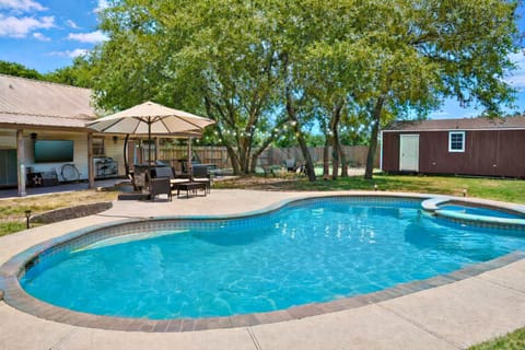 Relax by the private pool with lounge chairs and peaceful backyard views