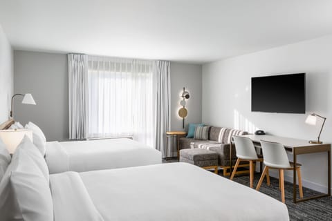 Premium bedding, desk, laptop workspace, blackout drapes