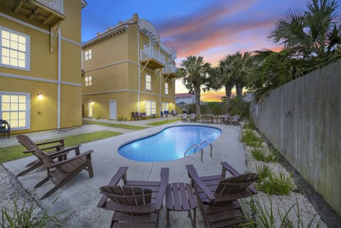 Relaxing semi-private pool with chairs and dining options.