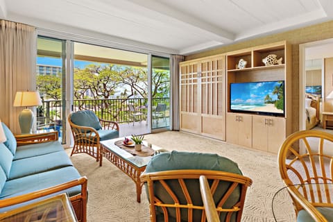 Unwind in a bright and welcoming living area, complete with a flat-screen TV and comfortable furnishings. Perfect for peaceful lounging.
