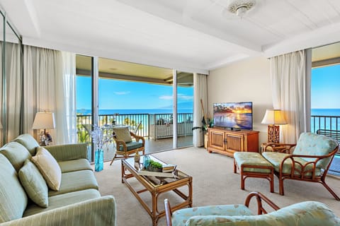 Unwind in a bright and welcoming living area, complete with a flat-screen TV and comfortable furnishings. Perfect for peaceful lounging.