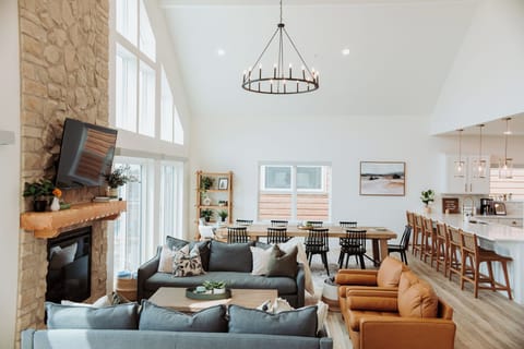 Cozy, spacious main floor living room w/ plenty of seating areas and a fireplace