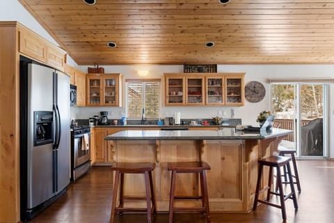 Breakfast bar with stainless steel appliances and open concept dining.
