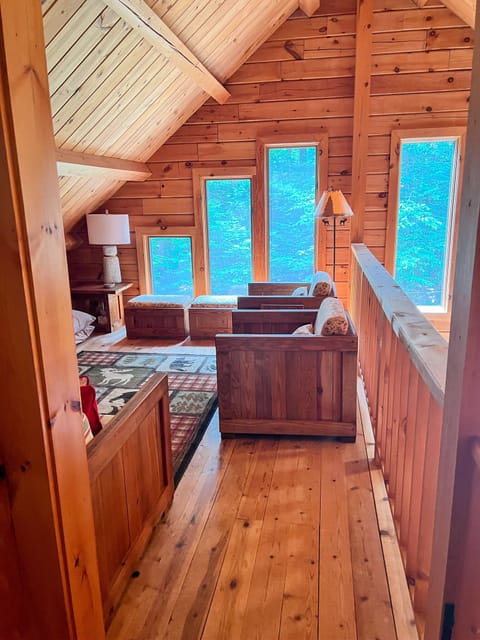 This inviting upstairs landing is a great place to relax, with a Smart TV, cozy seating, and windows that look out over the peaceful backyard. It’s a comfortable retreat for winding down while still staying close to the heart of the home.