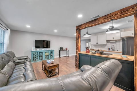 Living Room with Large Sectional Leather Sofa and Smart TV