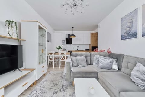 The elegant living room featuring a double sofa bed, perfect for relaxing or sleeping.