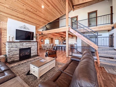 Soaring ceilings, stone fireplace, and open-concept living create the perfect mountain retreat.