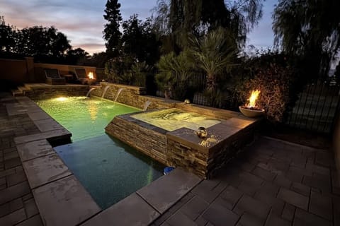 Impeccable dusk ambiance with a private pool and fire pits