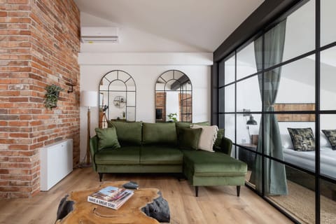 The elegant living area featuring a double sofa bed, perfect for relaxing or sleeping.