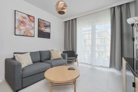 Relax in the stylish living room with a comfortable sofa and modern decor.