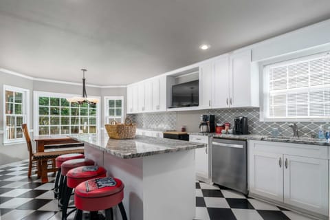 In this spacious kitchen, a granite top island bar doubles as an entertainment hub with an HDTV, while a complete set of cooking tools make meal preparation a breeze.