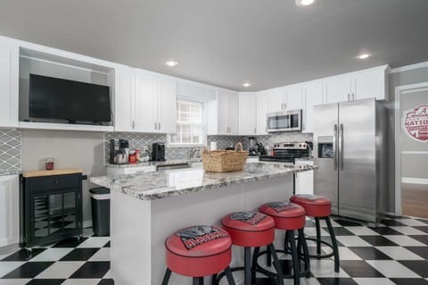 Roll Tide! This kitchen island bar features Alabama-themed stools, making every meal feel like a pre-game huddle for Crimson Tide fans.