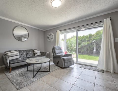 Modern living room with a sliding glass door opening to a private garden.