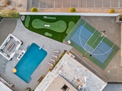 Resort-style backyard built for play—USPA-certified pickleball court, heated pool, half basketball court, and mini-golf all in one private space.