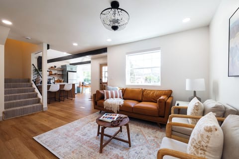 Living room: cozy seating, TV, coffee table books.