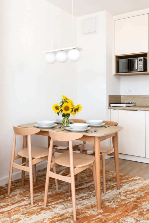 Fully equipped kitchenette with an induction hob, fridge with freezer, coffee machine, dishwasher, electric kettle and dining area