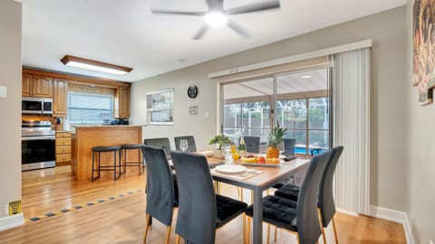 This dining area serves as the perfect hub for both delectable meals and effortless indoor-outdoor living.