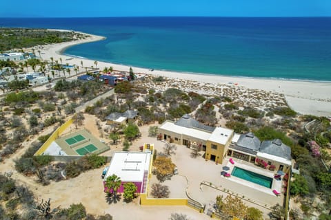 Beachfront home with pool and pickleball court.