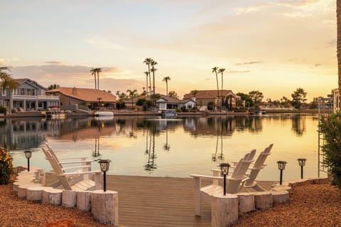 Lakeside view with four white Adirondack chairs