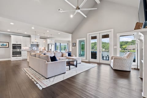 Spacious open-concept living room with vaulted ceilings and natural light.