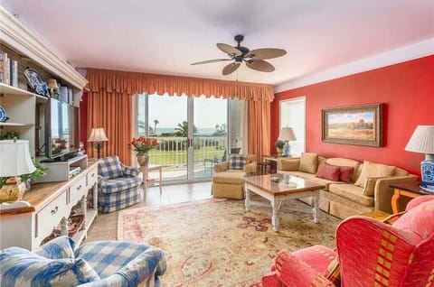 St. Simons Grand #113 Living space with sofa set, chairs, fan, and balcony access