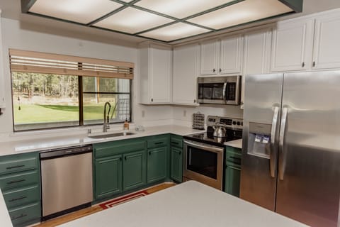 The kitchen is updated with new Fridigaire appliances and quartz countertops.